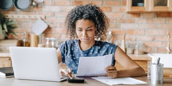 young woman looks at a financial document