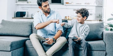 dad and son enjoy playing games together