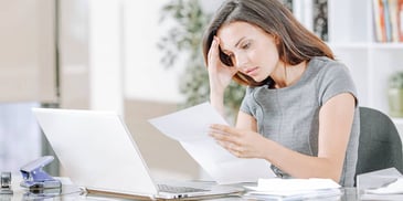 woman looks over her paperwork carefully