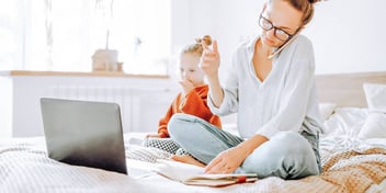 woman sitting with her child while completing divorce paperwork