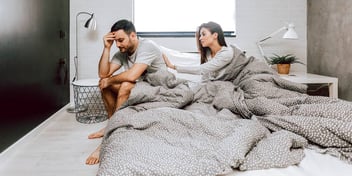 couple having an argument in bed