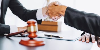 client shakes hand with judge for finalizing their divorce