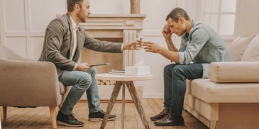 Mediator handing water to man in private