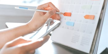 woman marking a calendar with changes