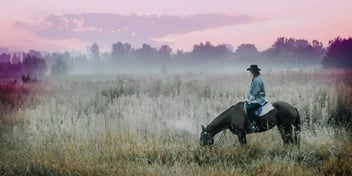 woman rides horse in colorado 