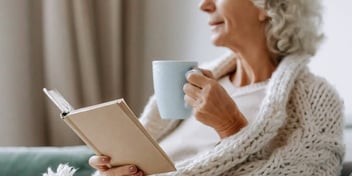woman with a soothing beverage creating a self-care plan in her journal