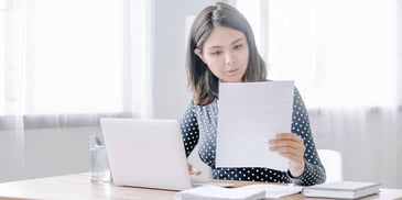 woman reviewing documents for financial disclosures
