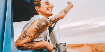 happy woman leaning out of truck window