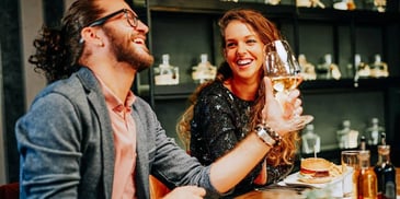 couple on a date laughing and drinking