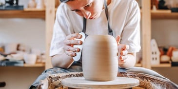 woman using pottery wheel