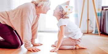 grandmother playing with her granddaughter on the floor
