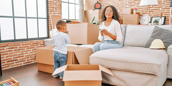 mom with son in a new home surrounded by moving boxes