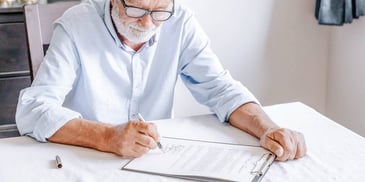 older man filling out a form