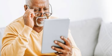 man looks at information on his tablet