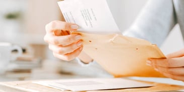 person preparing an envelope containing divorce paperwork