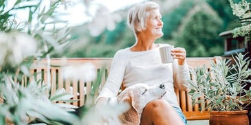 A happily divorced woman drinking a coffee with her dog