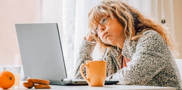stressed out woman going over her financial accounts online