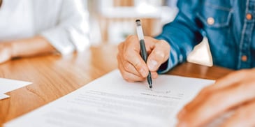 spouses signing divorce papers together without drama
