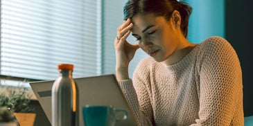 woman tired looking at computer