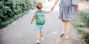 mom and son walking to school together