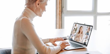 woman business owner on a zoom video call with staff