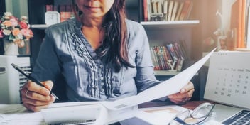 woman completes her divorce paperwork by herself at her desk