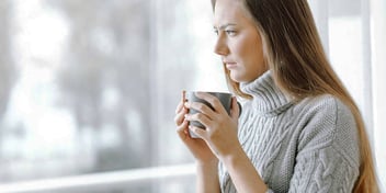 woman sipping a hot beverage as she thinks about ending her marriage