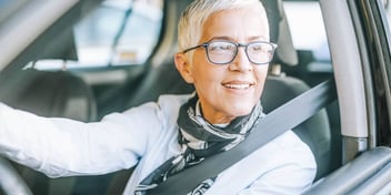woman driving car with glasses on